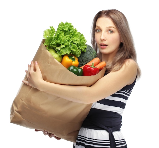 Girl with vegetable groceries young woman holding a bag of groceries from the grocery store