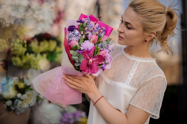 Girl with very cute bouquet in pink paper