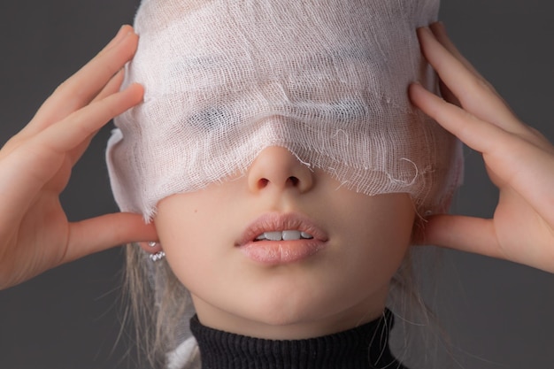 A girl with white gauze on her face