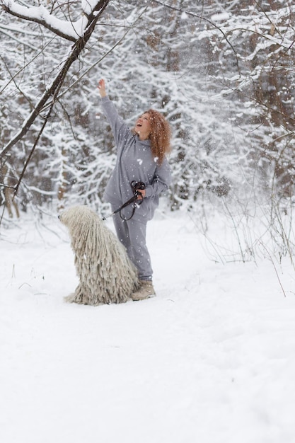 a girl in the woods with a big dog