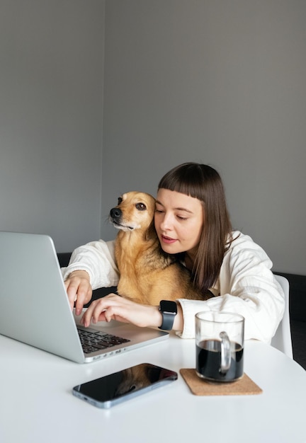 A girl working at home with her pet.