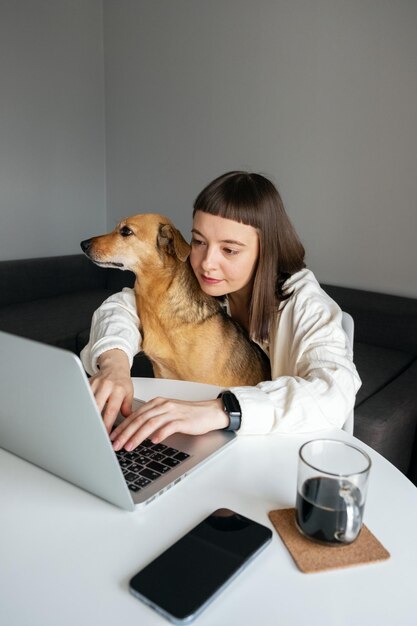 A girl working at home with her pet.