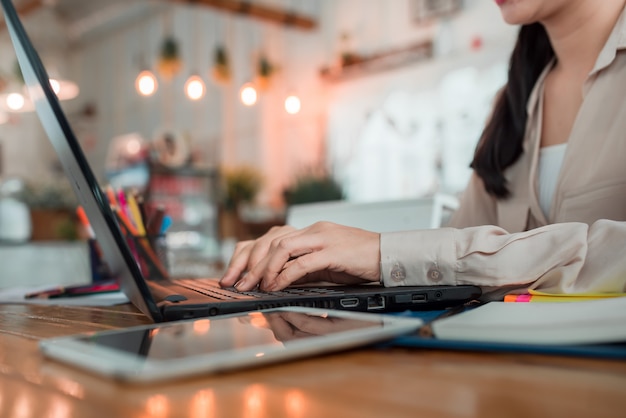 A girl working on a laptop computer is about to type