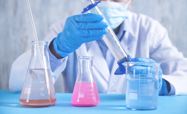 Girl working with flask in a laboratory.