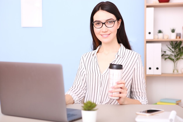 Girl works at a laptop at home