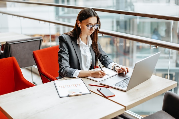 Girl works on a laptop in the office