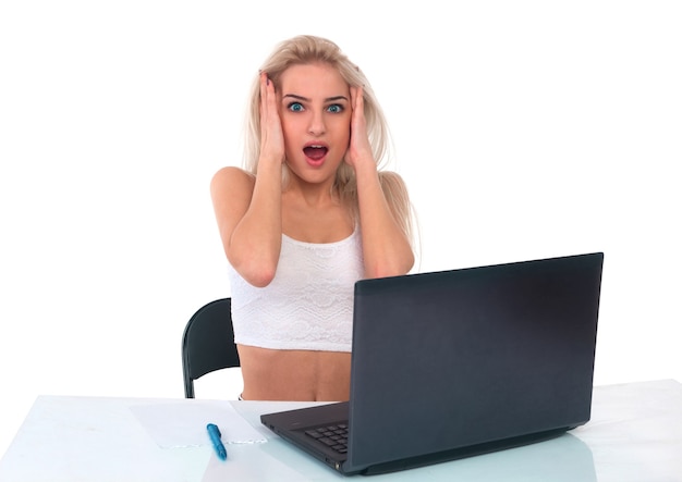 Girl works at a laptop on a white background