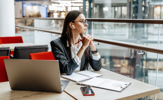 Girl works on a laptop in the workplace