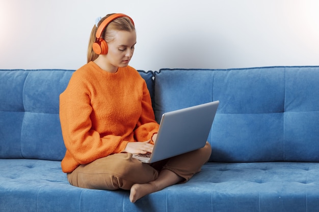 Girl works remotely at home at the computer