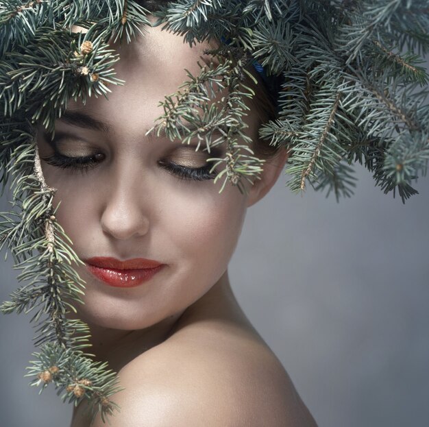 The girl in a wreath of fir branches