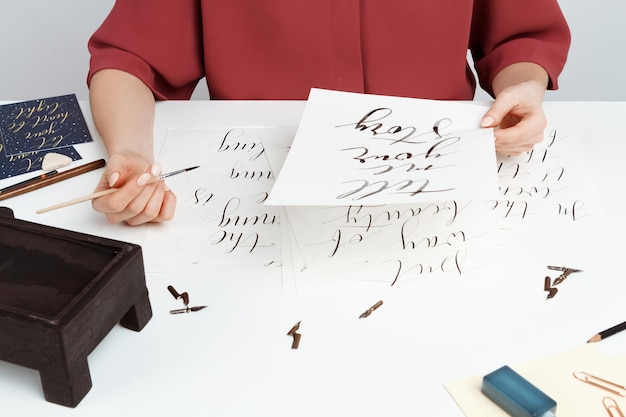 Girl writing calligraphy on postcards. Art design