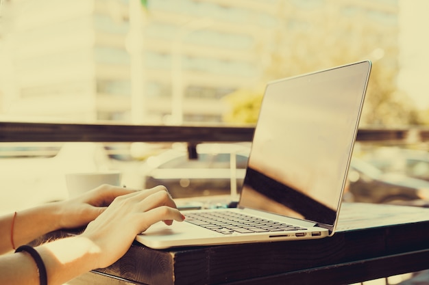 Girl writing on a laptop