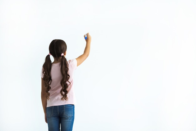 The girl writing on the white wall