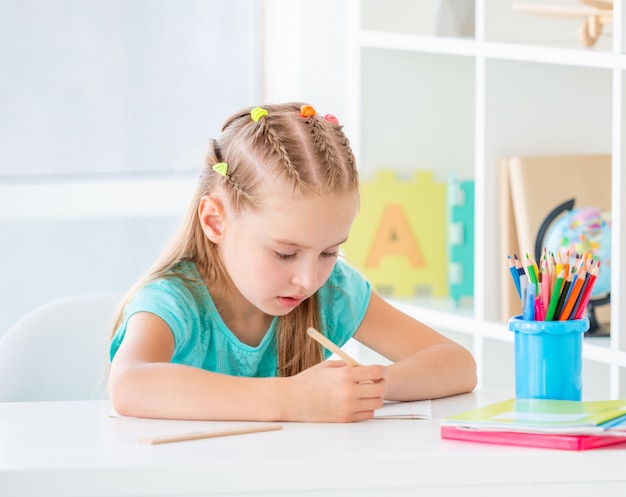 Girl writing with pencil