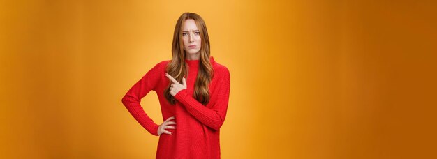 Girlfriend asking serious question being bothered by unfamiliar woman on family dinner pointing                         person