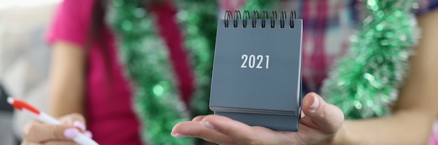 Girlfriend hold calendar 2021 in her hand.