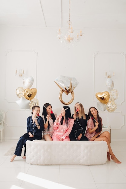 Girlfriends celebrating bachelorette party Stock photo of five girls in pajamas