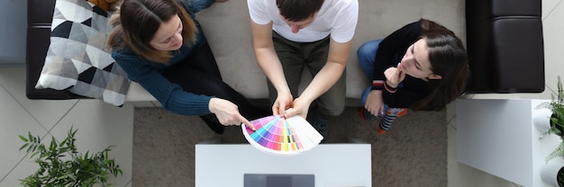 Girlfriends choose color from palette guy holds palette