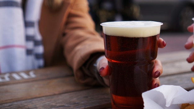 Girlfriends drink beer at the street food festival