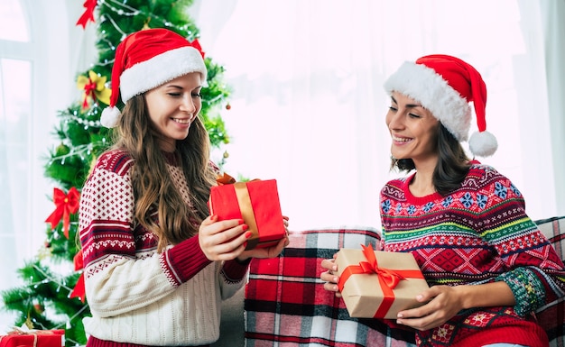 girlfriends at home wearing santa hat