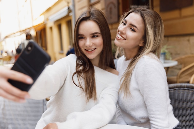 Premium Photo | Girlfriends taking selfies with the phone