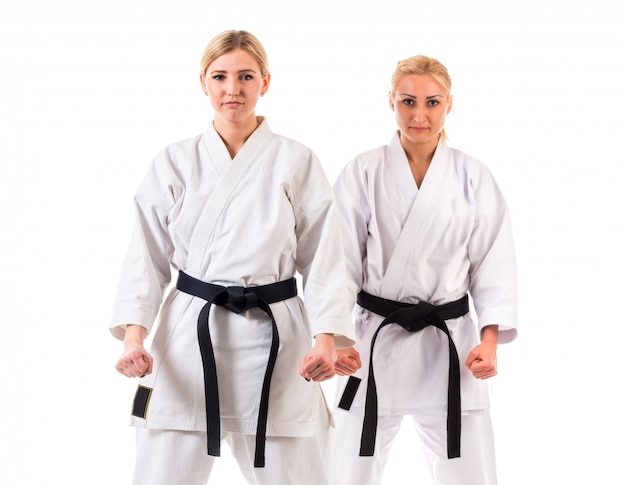 Girls athletes in karate kimono with black belts