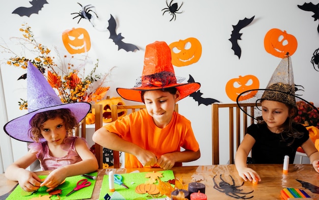 Girls doing autumn handicraft during creative workshop