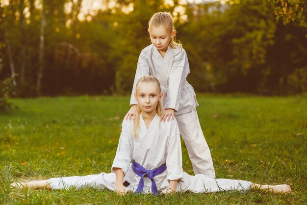 Girls dressed kimono doing karate exercises