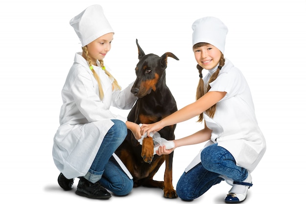 Girls dressed like doctors treated dog