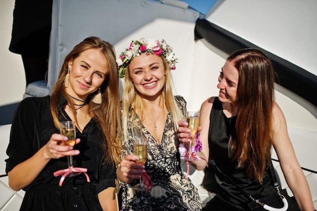 Girls drinking champagne at yacht on hen party