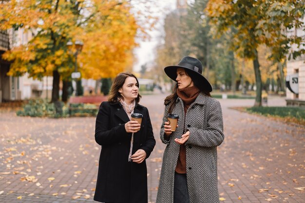 Girls drinking coffee in the park