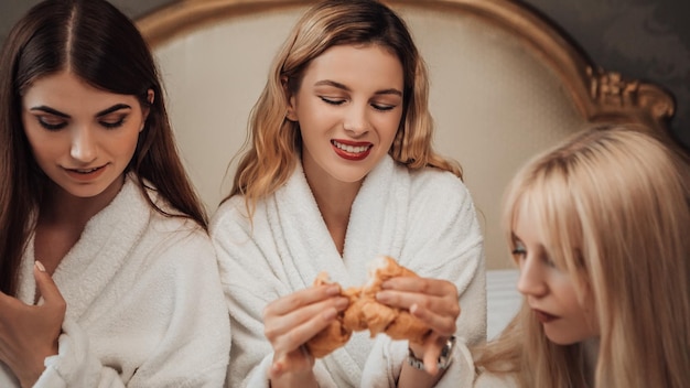 Girls eating in bed