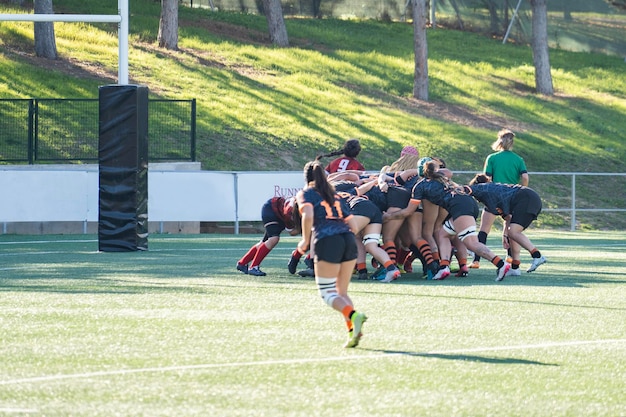 Girls fighting for the ball on a rugby match league