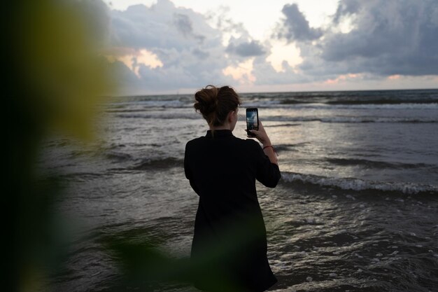 Girls filming a cloudy sunset on the phone