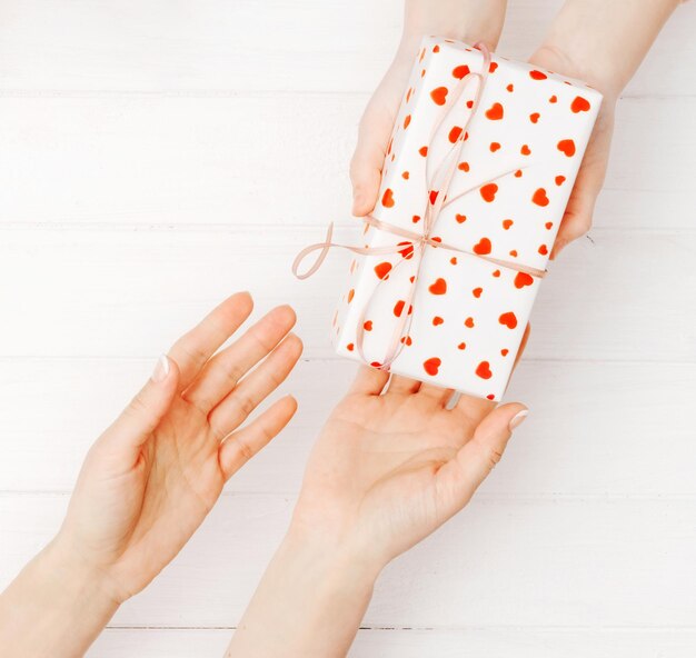 Girls hands holding lovely present box