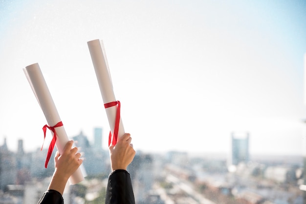 Girls holding up certificates with copy space