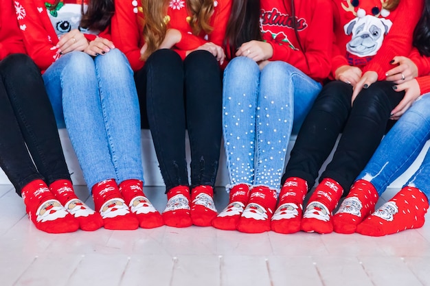 Foto gambe di ragazze con calzini di natale sul pavimento