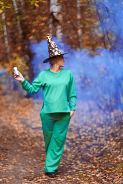 Girls in a magic forest with colored smoke