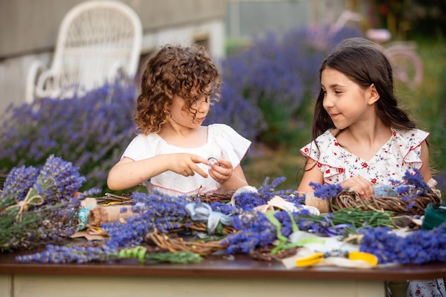 Girls make homemade lavender wreaths as a decor for home or present