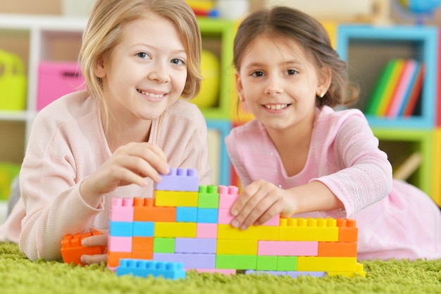 Girls playing with colorful blocks