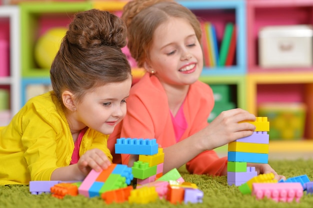 Girls playing with colorful blocks