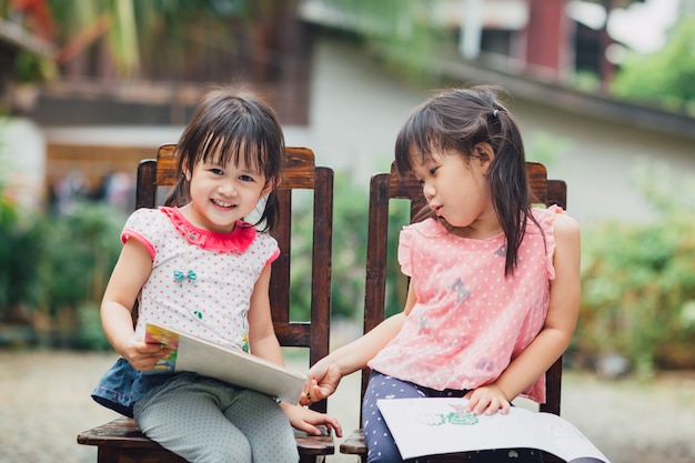 Girls playing with coloring books