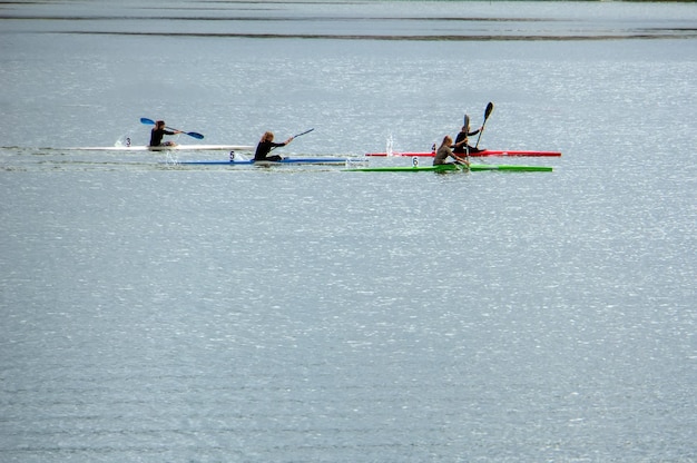 Girls rowing on kayaks on the lake