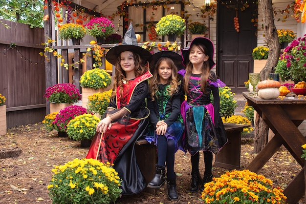 girls sisters in witch costumes have fun celebrating halloween