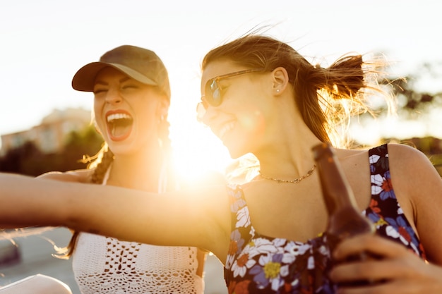 Girls smiling with the sun in the middle