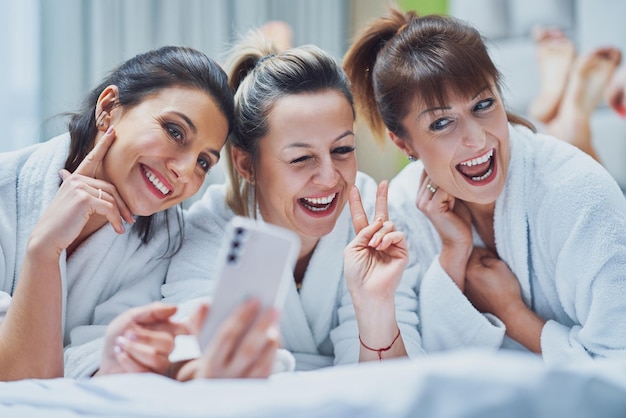 Girls at spa party in hotel with phone