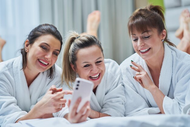 Girls at spa party in hotel with phone