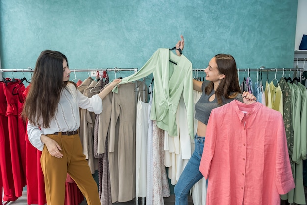 girls spending time for shopping in the fashion store