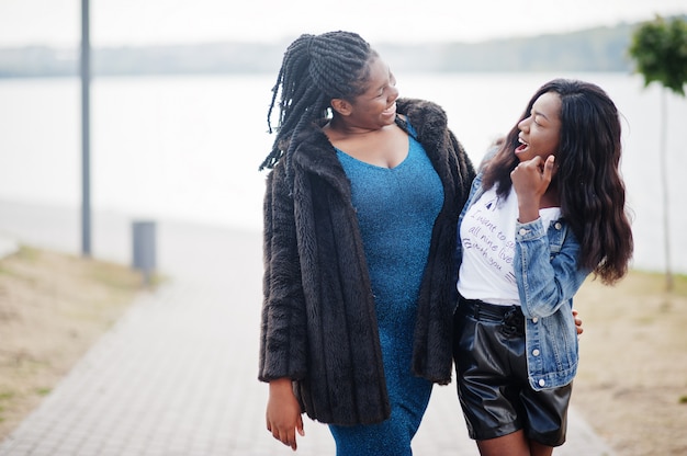 Girls in stylish outfits posing together