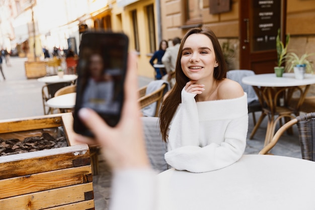 girls taking photos to each other at the cafe